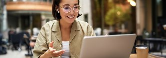 Professional discussing a project while working on a laptop